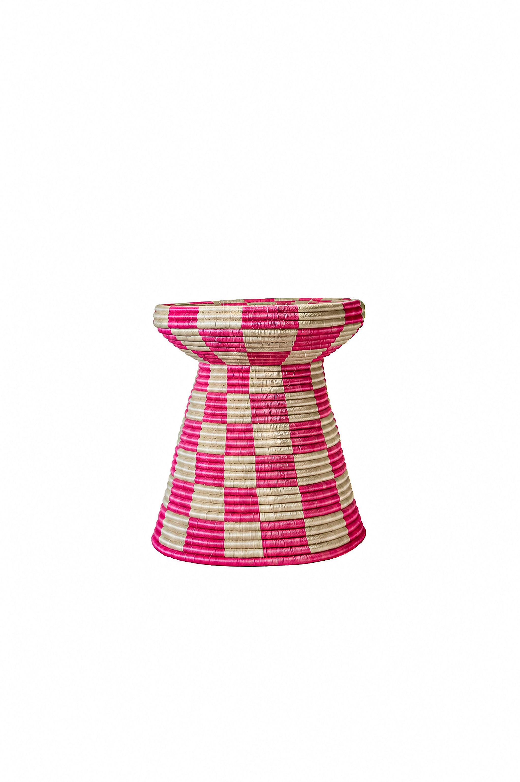 A woven basket stool with a tiered design, featuring a checkered pattern of vibrant pink and natural beige raffia on a solid white background.