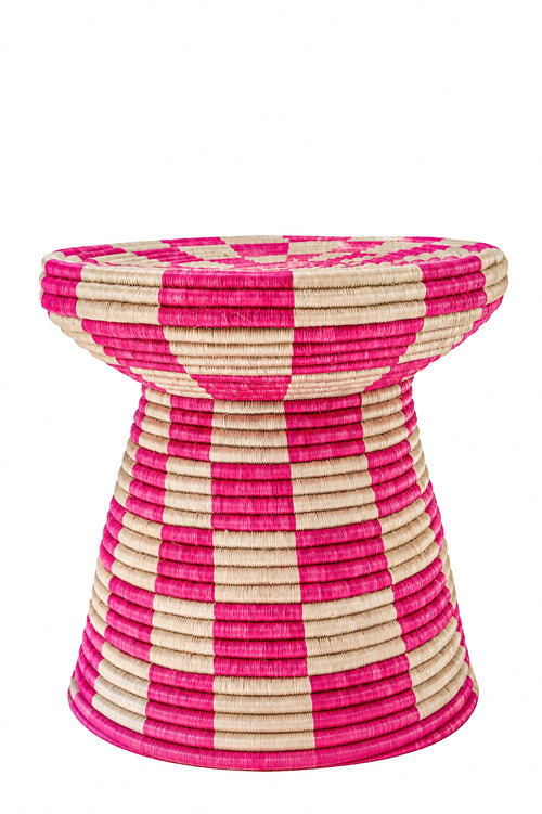 A woven pedestal stool with a bold pink and natural beige checkerboard pattern, isolated on a white background.
