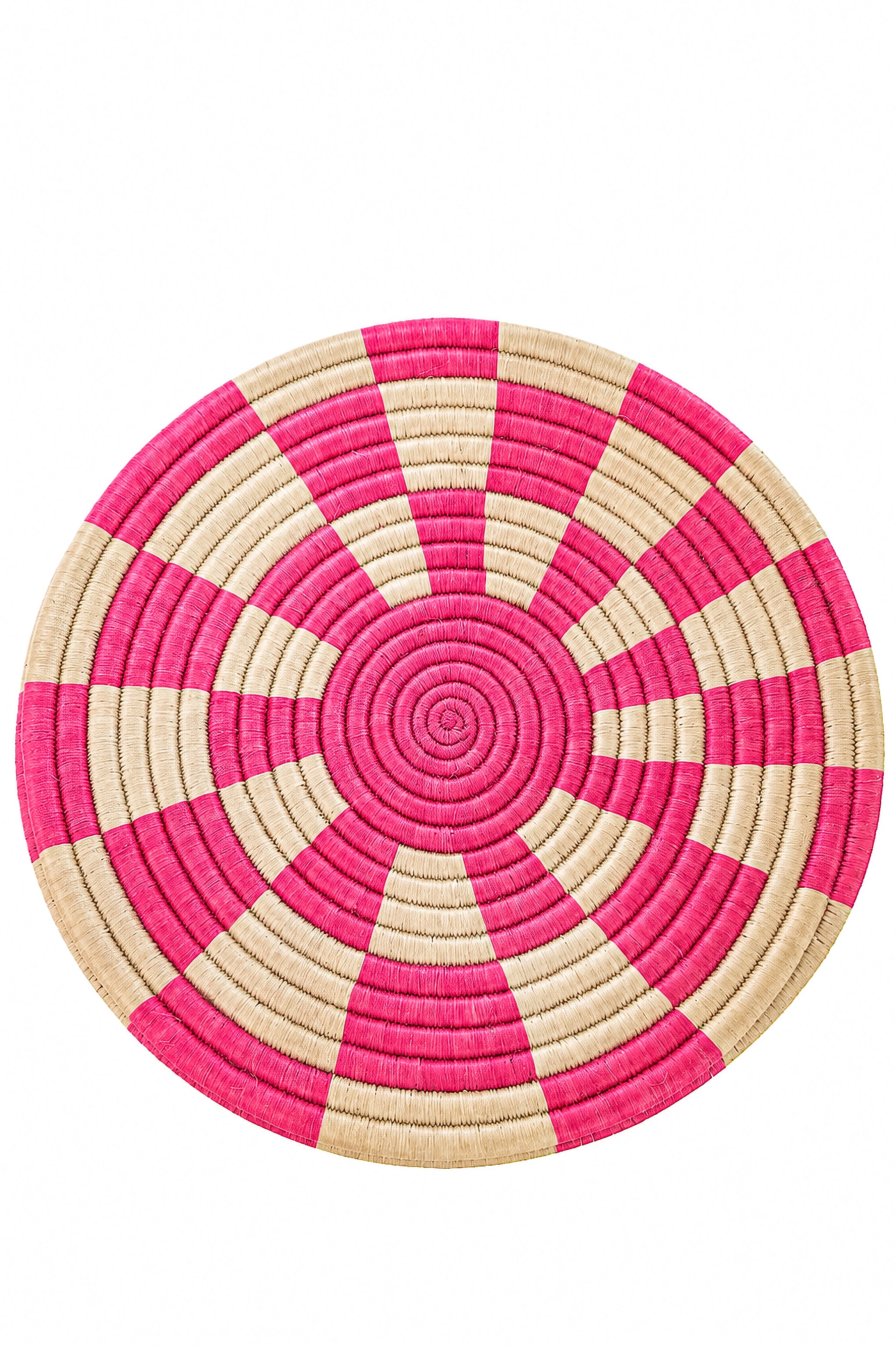 A round woven placemat with a geometric spiral pattern in vibrant pink and natural beige, isolated on a white background.
